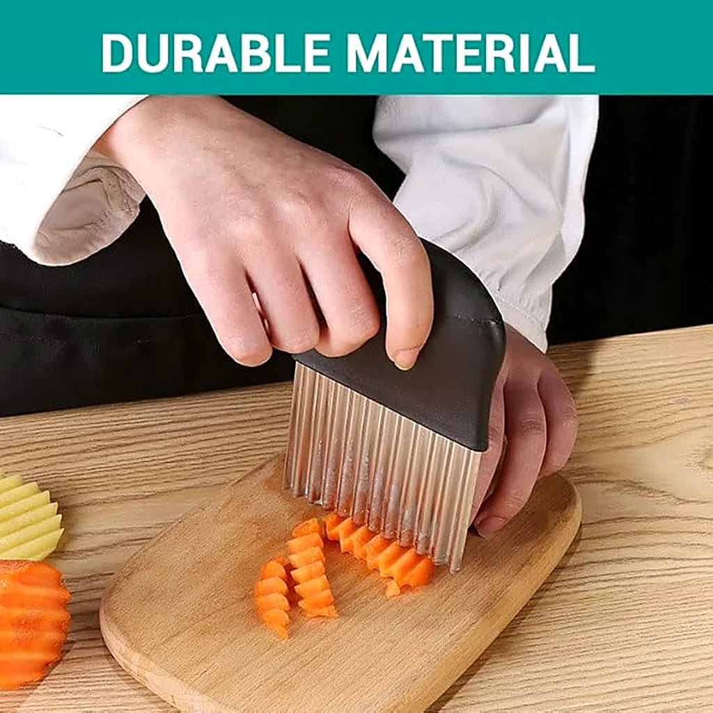 Close-up of the stainless steel crinkle cutter slicing carrot sticks on a wooden board