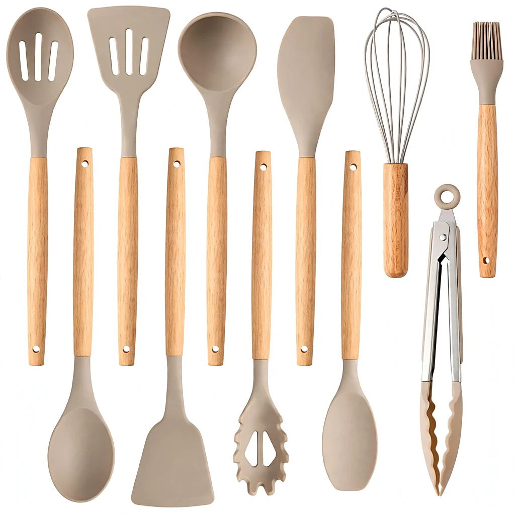 All twelve khaki silicone utensils with wooden handles laid out on white, including pasta server, tongs and whisk