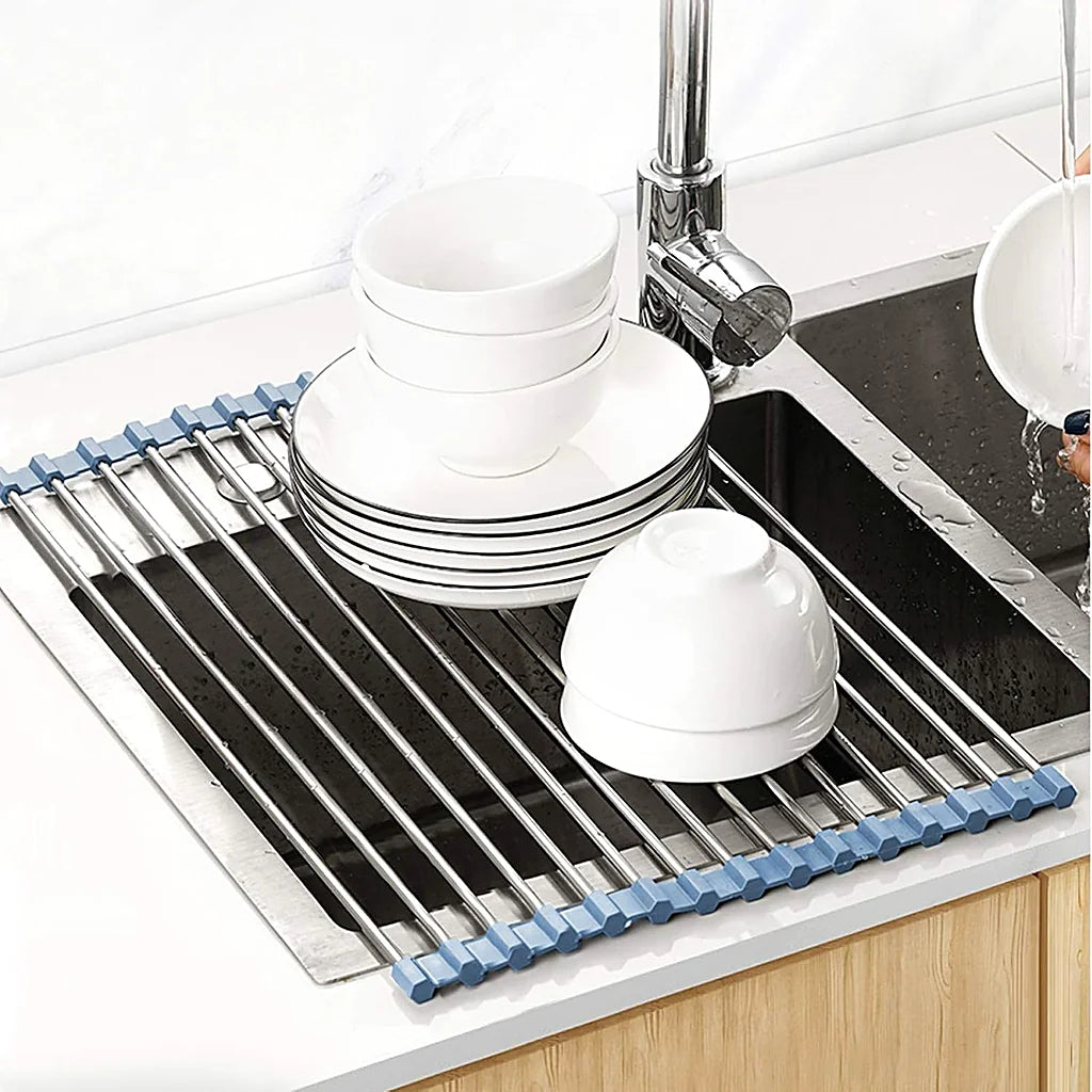 Stack of white plates and bowls drying on the roll-up rack over a kitchen sink