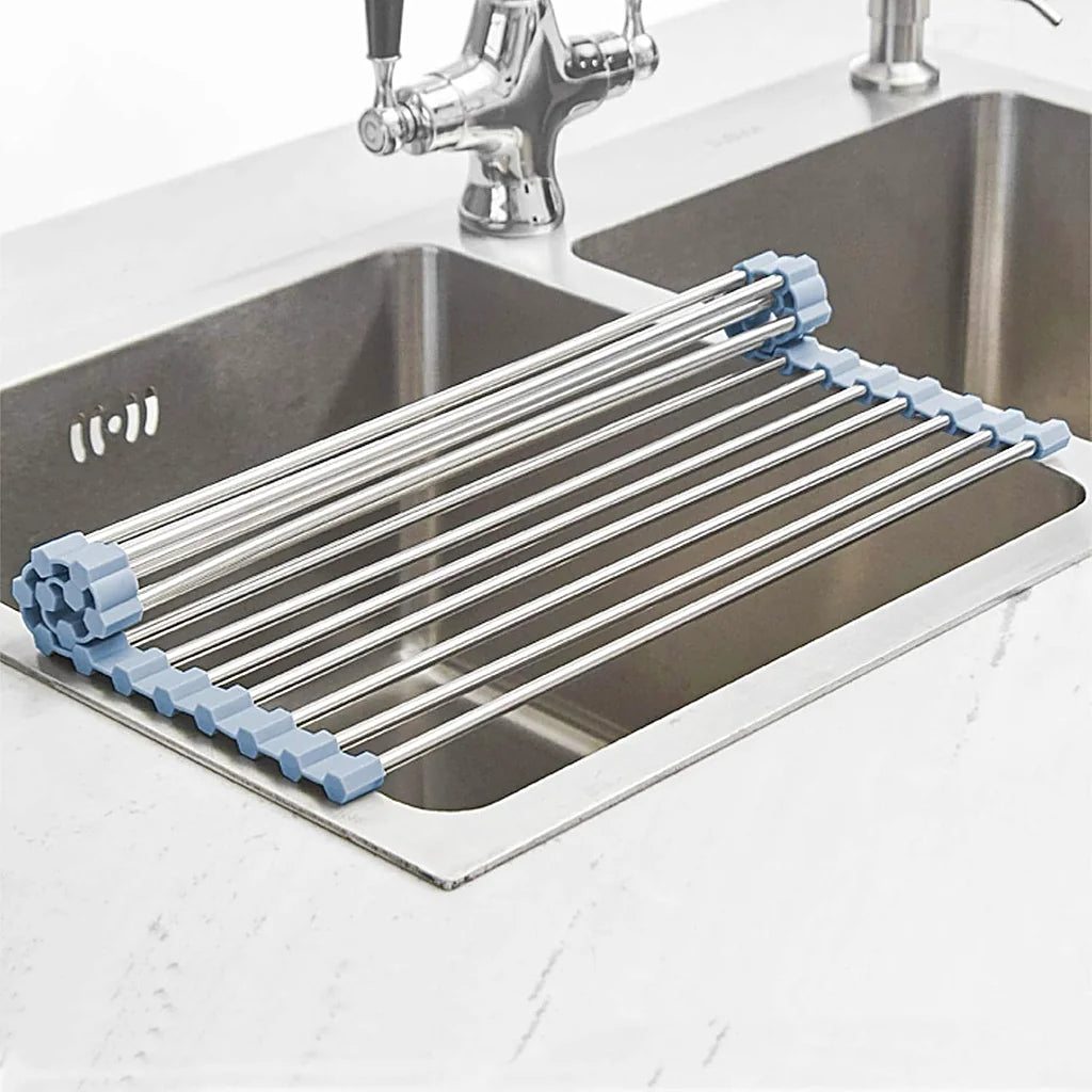 Roll-up dish rack partially rolled up over a stainless steel double sink with a bridge faucet