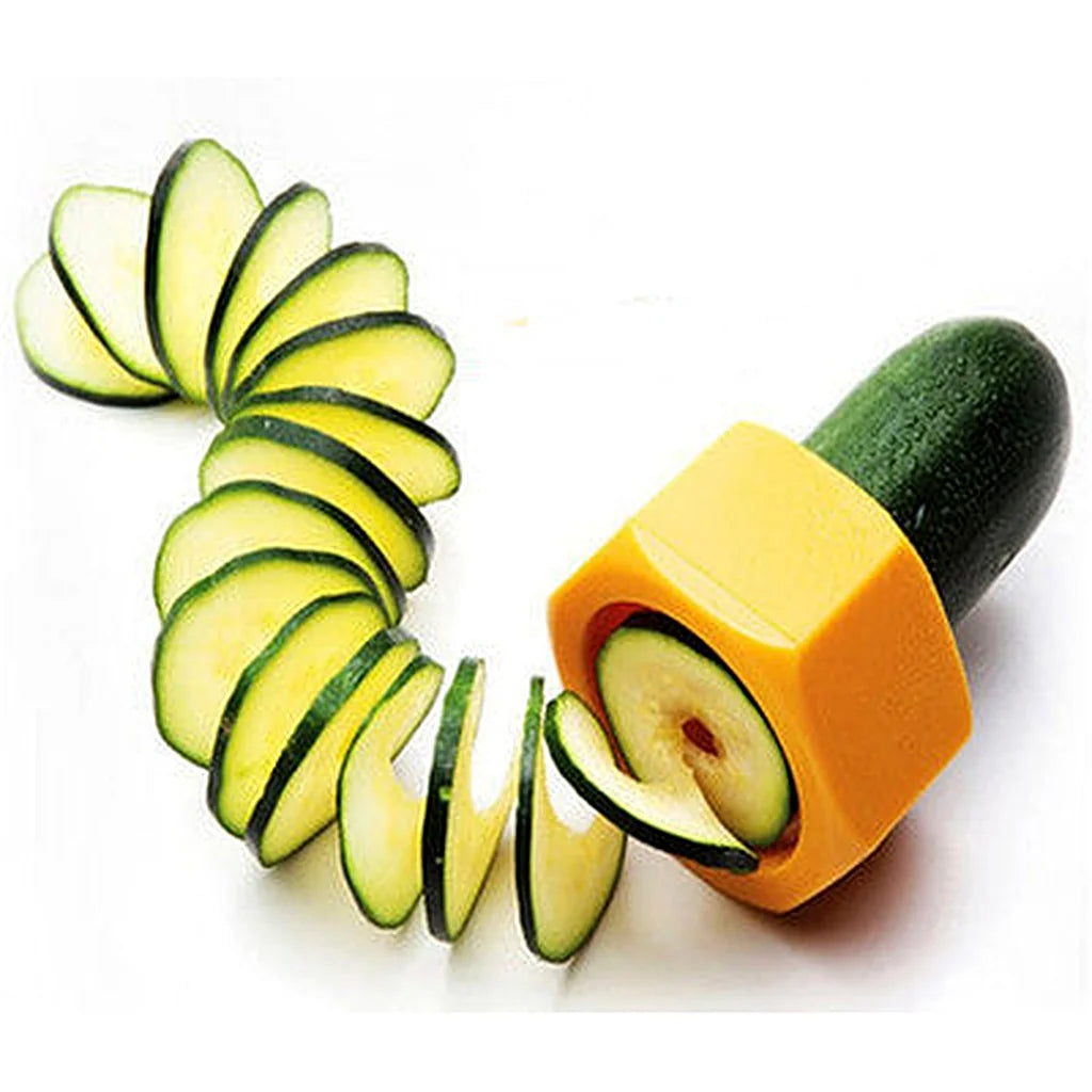 Close-up of the orange spiral cutter slicing a zucchini into a fanned spiral of thin rounds on white