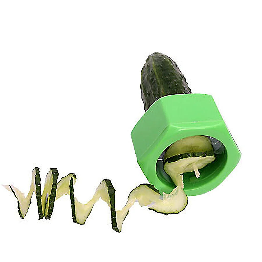 Green spiral cutter on a cucumber with a wavy spiral ribbon of cucumber peel trailing from it on white