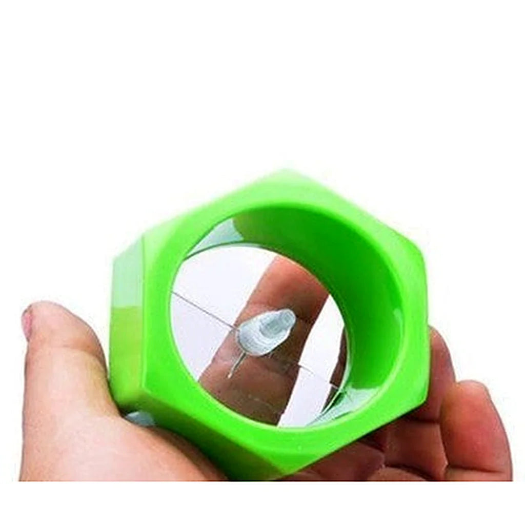 Hand holding the green spiral cutter to show the central spike and blade inside the ring