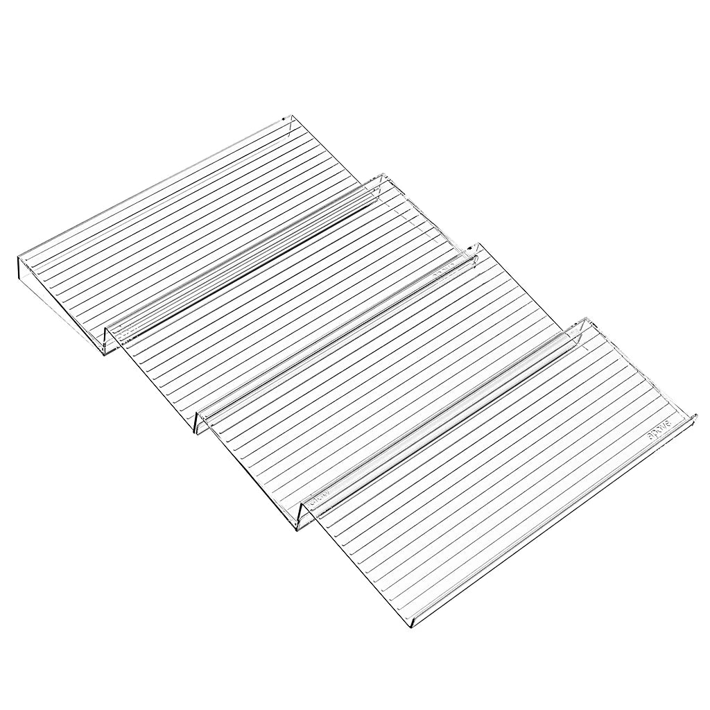 Four empty clear stepped spice rack tiers arranged in a row on a white background