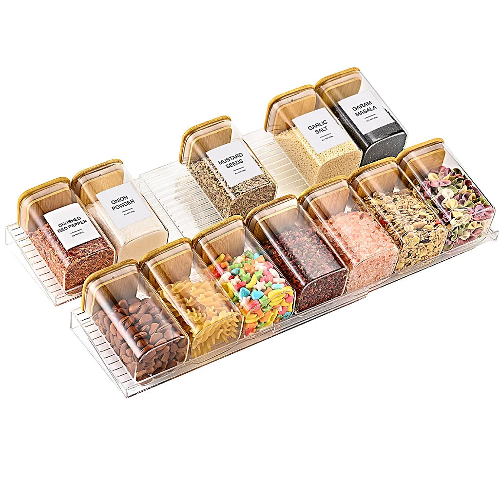 Labeled spice jars arranged on the clear stepped rack tiers against a white background