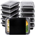 Two stacks of black meal prep containers with clear lids, and one in front filled with rice, corn and broccoli