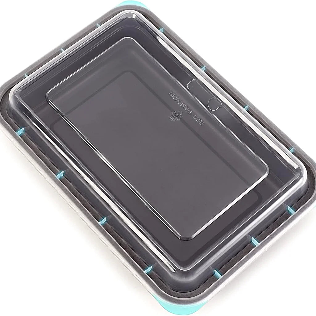 Underside view of a clear container lid on a dark meal prep container, showing the recessed panel and molded symbols