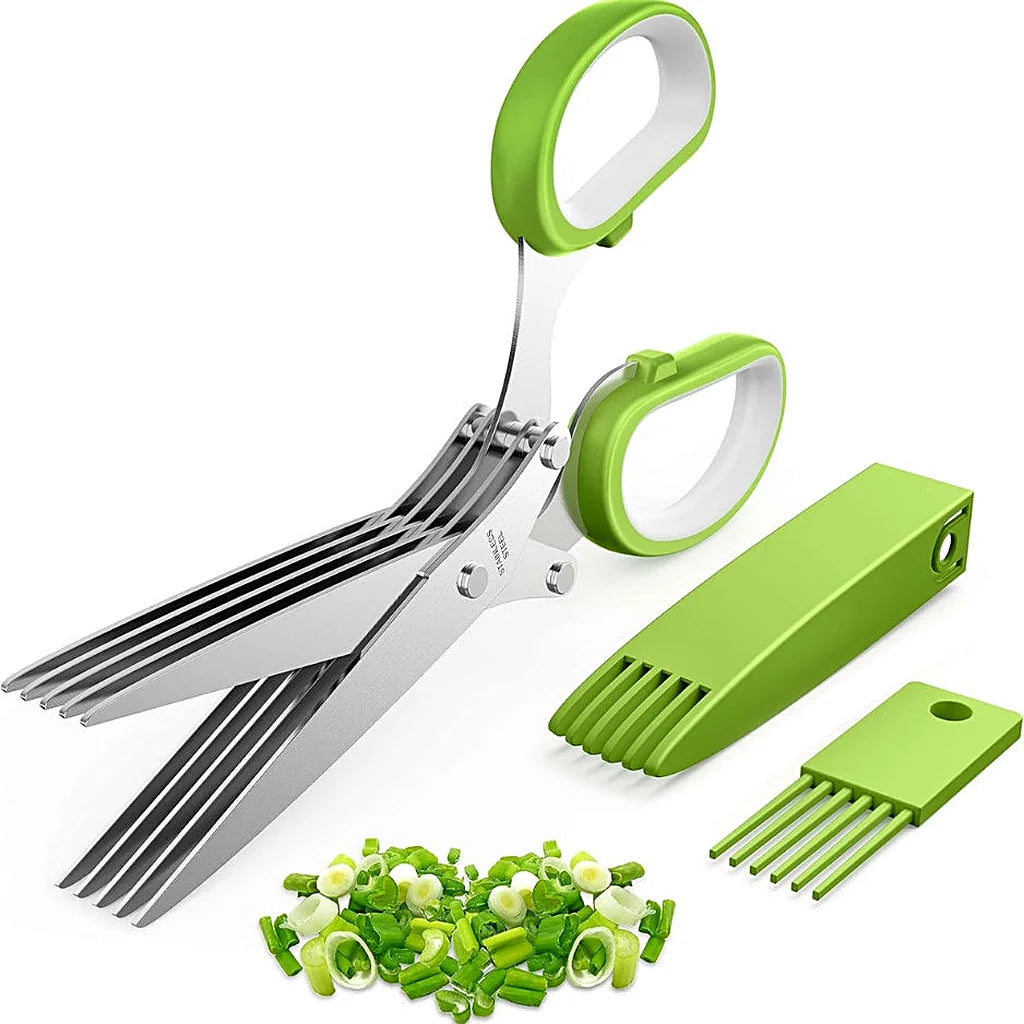 Green-handled five-blade herb scissors open above chopped green onions, with blade cover and cleaning comb beside them
