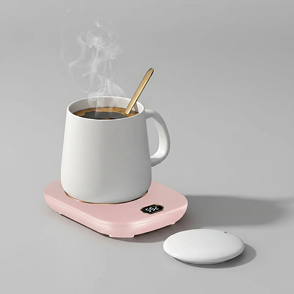 Steaming white mug on a pink mug warmer, with the mug lid resting beside it