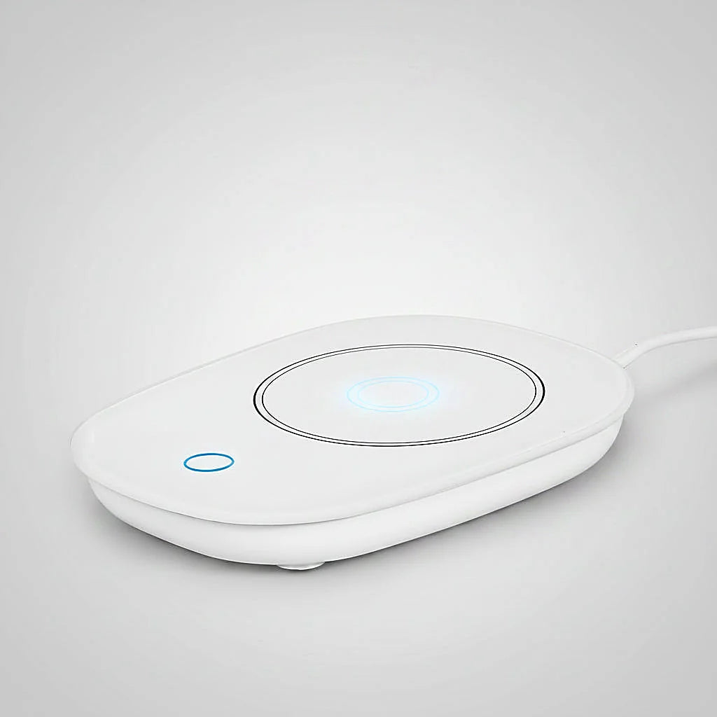 White mug warmer with glowing blue indicator lights on a light gray background
