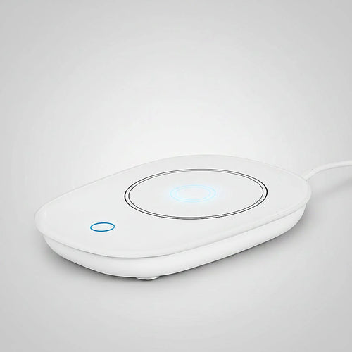 White mug warmer with glowing blue indicator lights on a light gray background