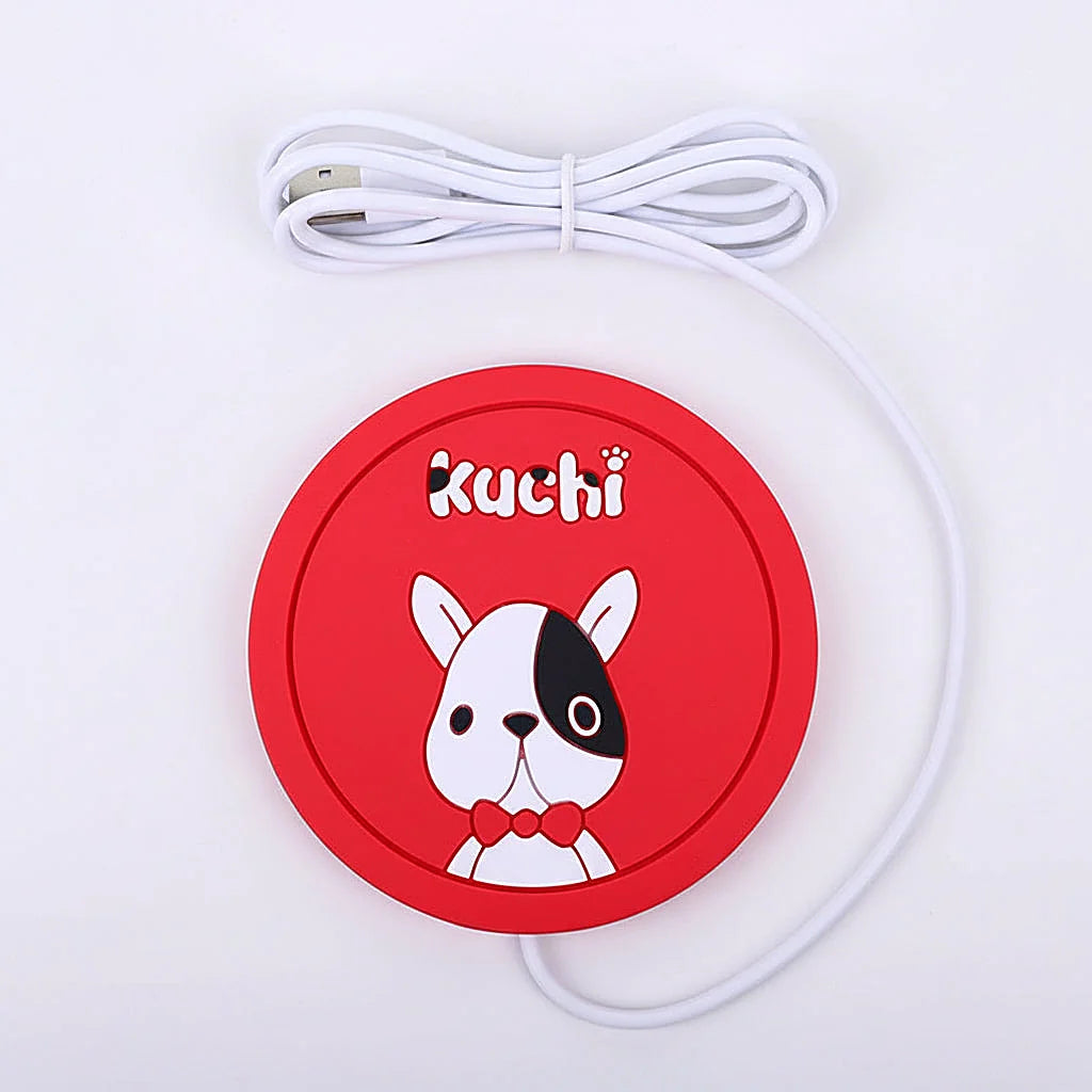 Red USB warmer pad with a cartoon dog face beside its coiled USB cable on a white background